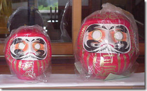 Daruma dolls, still in their protective plastic wrapping