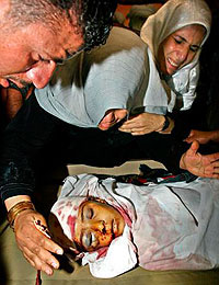 Medics treat a Palestinian boy who was wounded in an Israeli air strike in Gaza City