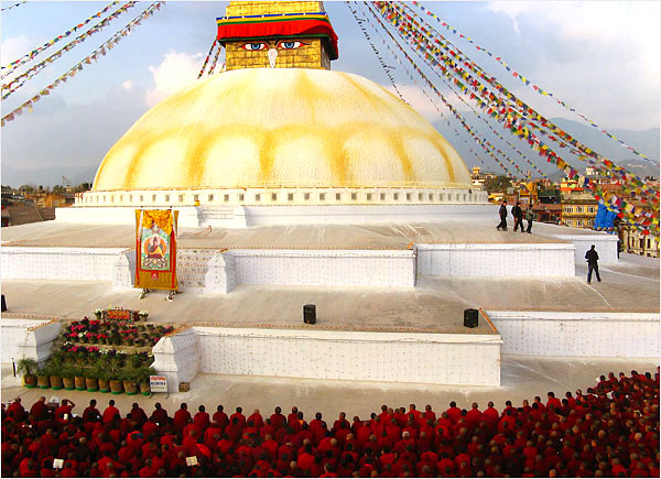 Tibetan monks sit and chant at the holy stupa, or temple, in Boudhanath as the eyes of the Buddha peer down.