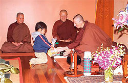 Giving alms to the abbot and learning that it is possible to practise in an all-woman environment with female dharma teachers. PHOTOS COURTESY OF THE DHAMMASARA NUNS MONASTERY