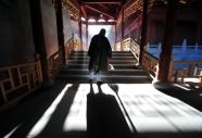 A buddhist nun performs her morning chore of sweeping the floor at Wutaishan, literally 