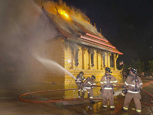 Firefighters work to get a fire under control Tuesday morning at a Buddhist temple in northwest Fort Worth.