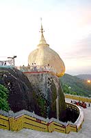 Kyaikhtiyo Pagoda or the Golden Rock draws Buddhist pilgrims all year round. The 22 feet pagoda sits on a slanting face of a rock. Kyaikhtiyo Pagoda or the Golden Rock draws Buddhist pilgrims all year round. The 22 feet pagoda sits on a slanting face of a rock.