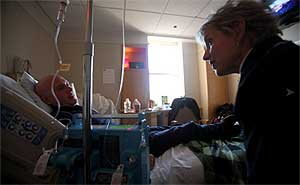 Chaplain Anne Reigeluth visits cancer patient Toni Siniscachi. Ms Reigeluth, 57, a Buddhist ,is training under two Buddhist monks