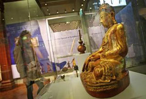 EXPLORING LINKS: Above, a wooden Buddha from the 18th/19th Century. Right, an 11th Century votive stupa. These are constructed to commemorate visits or to gain spiritual benefits