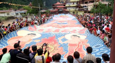 The thanka, a giant canvas painting of Sakyamuni Buddha, is unfurled at the Enlightened Heart Buddhist Centre in Tambun.