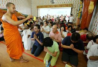 Devotees at the Buddhist Maha Vihara in Kuala Lumpur performing prayers on Wesak Day.
