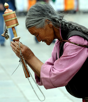 A faithful prays in Lhasa, southwest China's Tibet Autonomous Region, while celebrating the peak day of the Sakadawa Festival