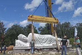 Crews lift 40-ton statue into place at Buddhist center A crew carefully lifted the granite statue depicting religious figure on his death bed, moving it a few feet at a time.