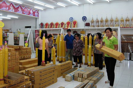 Customers survey goods before the Khao Phansa holiday. Customers survey goods before the Khao Phansa holiday.