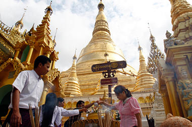 Buddhist devotees pour water on a Buddha statue at the Shwedagon Pagoda on Oct 10, 2013, in Yangon, Myanmar.