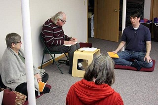 A Buddhist study group discusses various practices during its weekly gathering at the Holistic Heath Center on Sunday.