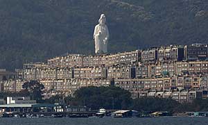 Tsz Shan monastery’s bronze-forged white statue, stands behind luxurious houses in the Taipo district of Hong Kong. Photograph: Bobby Yip/Reuters
